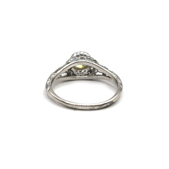 Platinum Art Deco diamond ring with intricate geometric design and sparkling diamonds, showcasing elegant craftsmanship.