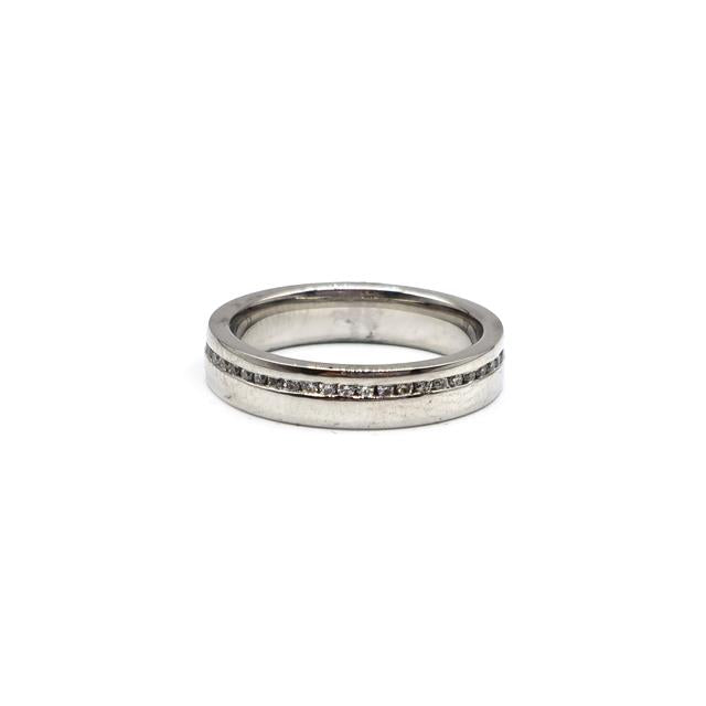 Close-up of a platinum diamond ring with a central sparkling diamond, showcasing elegant craftsmanship and a polished finish.