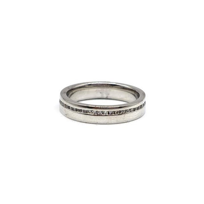 Close-up of a platinum diamond ring with a central sparkling diamond, showcasing elegant craftsmanship and a polished finish.