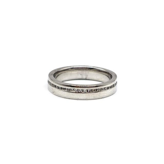 Close-up of a platinum diamond ring with a central sparkling diamond, showcasing elegant craftsmanship and a polished finish.