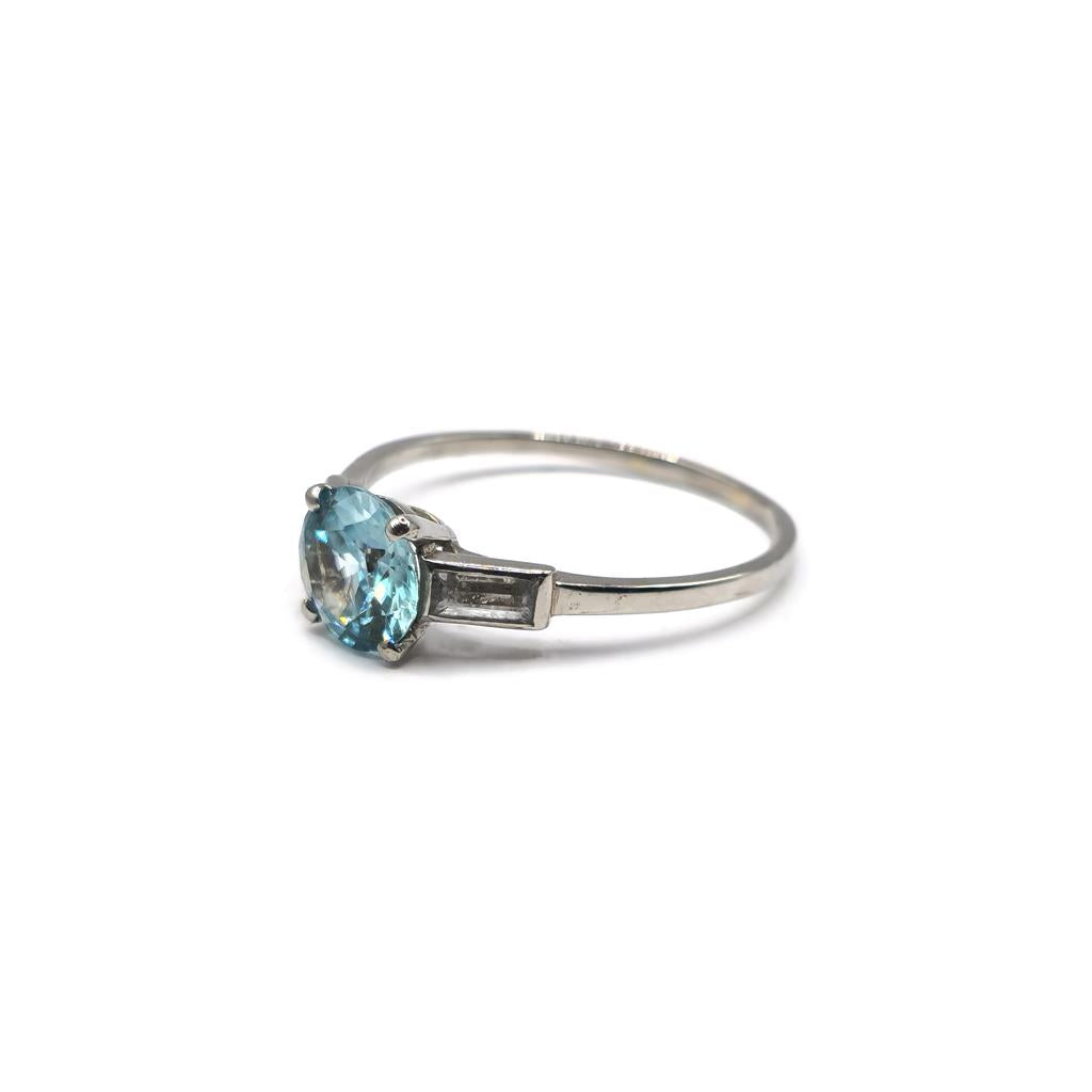 Platinum topaz and cubic zirconia ring with a polished band, showcasing sparkling gemstones and elegant design.