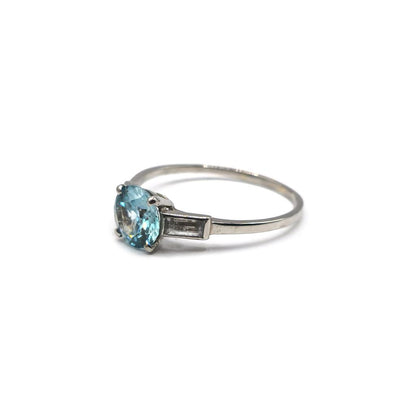 Platinum topaz and cubic zirconia ring with a polished band, showcasing sparkling gemstones and elegant design.