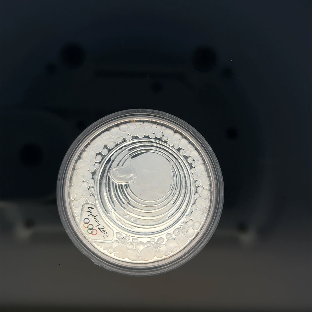 Silver 2000 Olympic coin, 31.4g, unbranded silver coin featuring Olympic design, detailed and shiny surface.