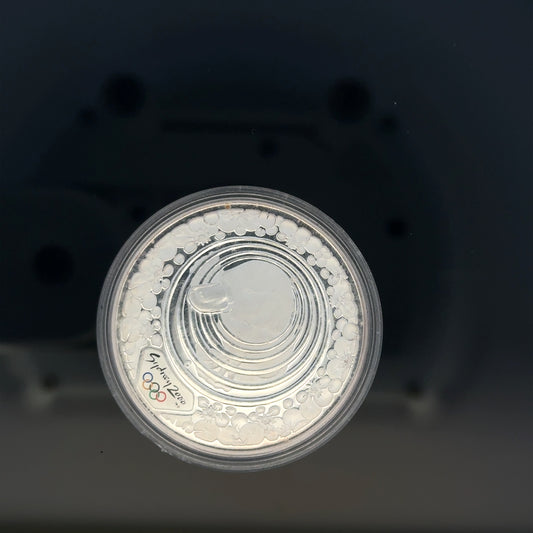 Silver 2000 Olympic coin, 31.4g, unbranded silver coin featuring Olympic design, detailed and shiny surface.
