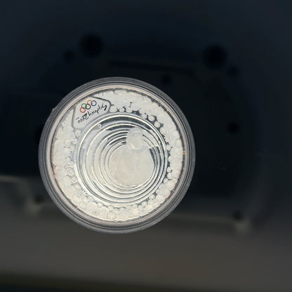 Silver 2000 Olympic coin, 31.4g, featuring Olympic design, unbranded silver coin with detailed engravings.