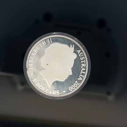 Silver 2000 Olympic coin, 31.4g, unbranded silver coin featuring Olympic designs, displayed on a neutral background.