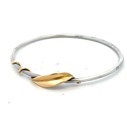 Silver bangle bracelet weighing 13.3g with a simple, polished design, unbranded, displayed on a neutral background.