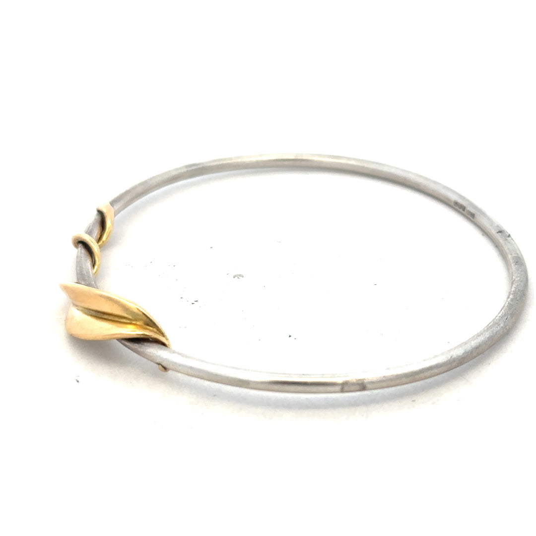 Silver bracelet bangle weighing 13.3g, unbranded, showcasing a smooth, shiny silver finish on a plain bracelet design.
