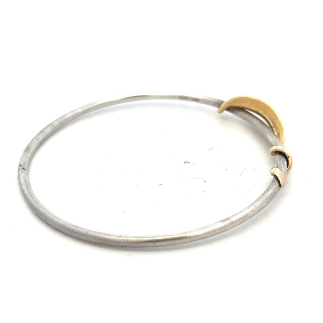 Silver bracelet with a smooth, polished finish, weighing 13.3g, showcasing a stylish unbranded bangle on a neutral background.
