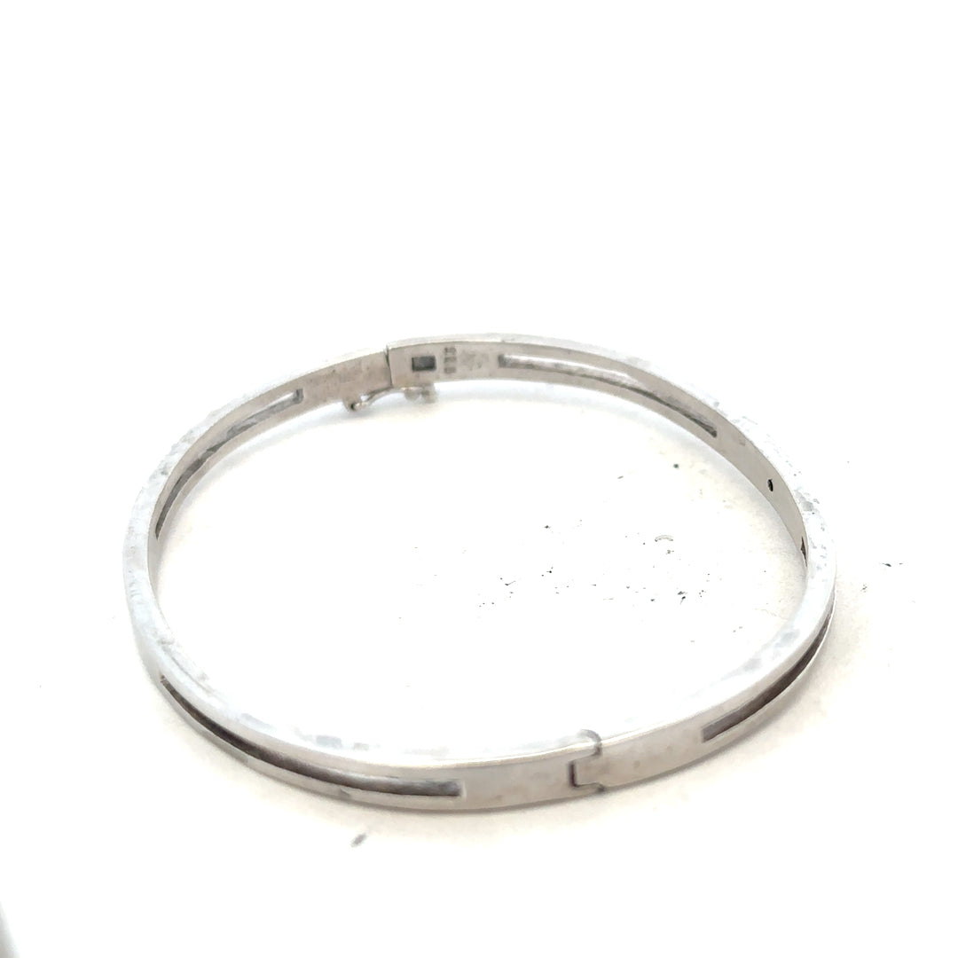 Silver unbranded bracelet bangle weighing 13.5g, featuring a sleek, polished design with smooth curves and a shiny finish.