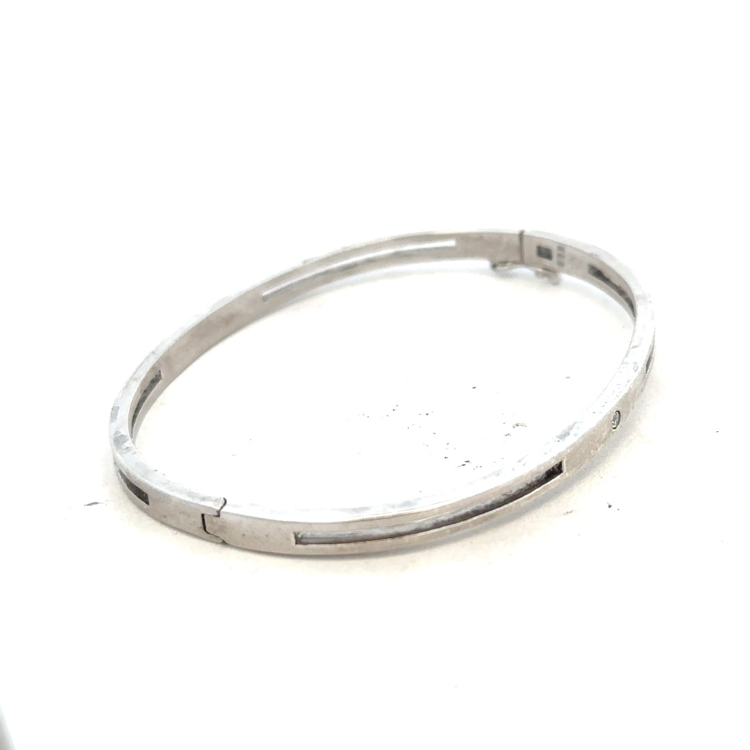 Silver bangle bracelet weighing 13.5g with a smooth, polished finish, designed for elegant wrist jewelry.