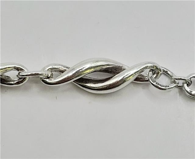 Silver bracelet measuring 19cm, weighing 14.4g, featuring a sleek unbranded design with a polished finish.