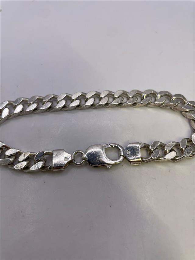 Silver bracelet weighing 33.8g with intricate design, unbranded jewelry accessory perfect for stylish wristwear.