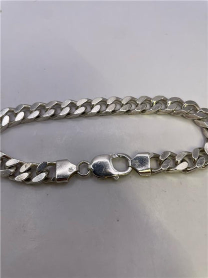 Silver bracelet weighing 33.8g with intricate design, unbranded jewelry accessory perfect for stylish wristwear.