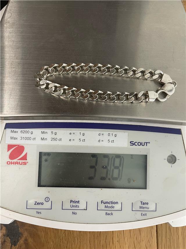 Silver bracelet weighing 33.8g with a sleek, polished finish, featuring classic chain links, unbranded jewelry accessory.
