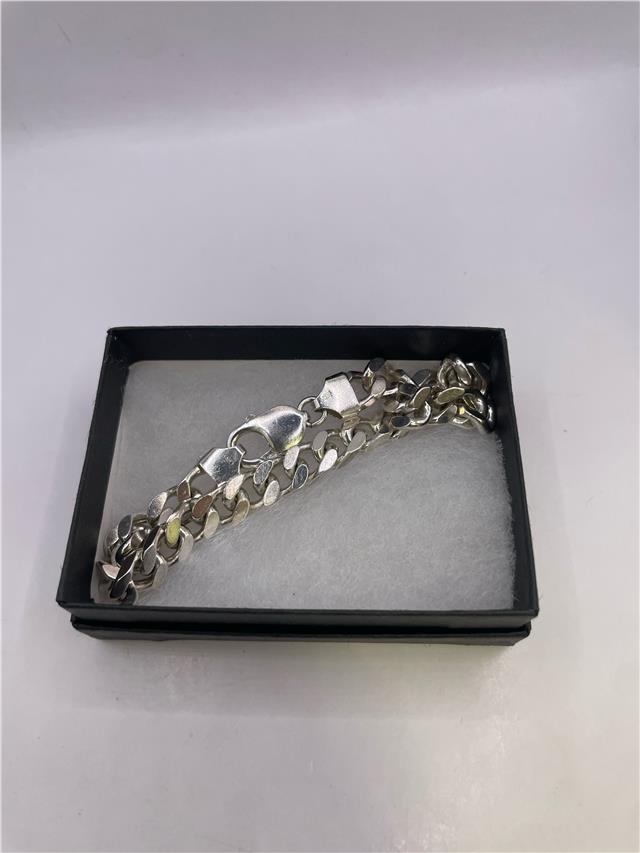 Silver bracelet weighing 33.8g, featuring a sleek design, displayed on a neutral background.