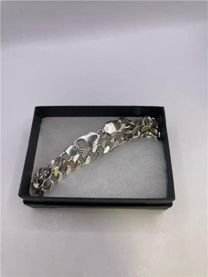 Silver bracelet weighing 33.8g, featuring a sleek design, displayed on a neutral background.