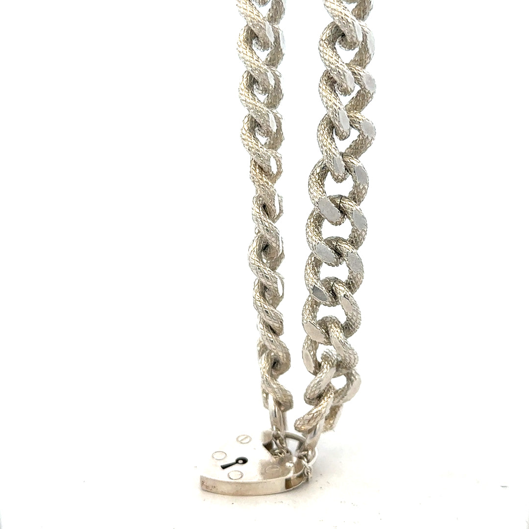 Silver bracelet weighing 64.4g with intricate design, crafted from unbranded sterling silver, shown on a plain background.