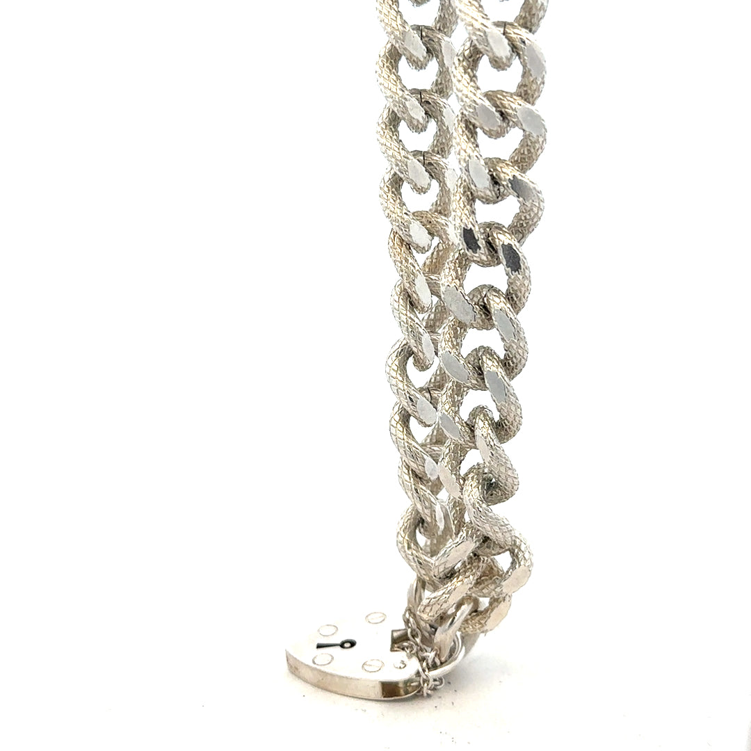 Silver bracelet weighing 64.4g with intricate design, unbranded, displayed on a neutral background.