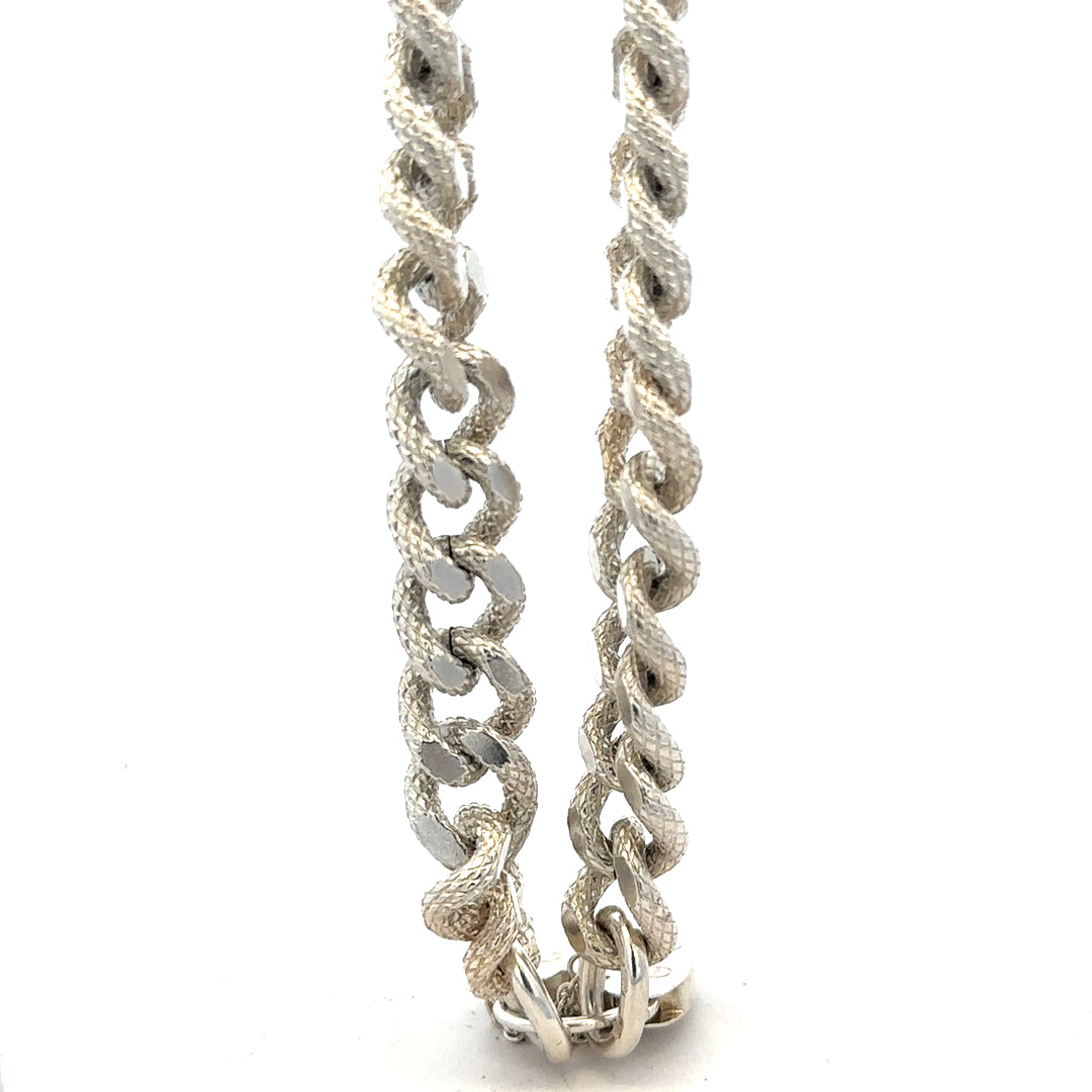 Silver bracelet weighing 64.4g with intricate design, crafted in a classic style, shown on a neutral background.