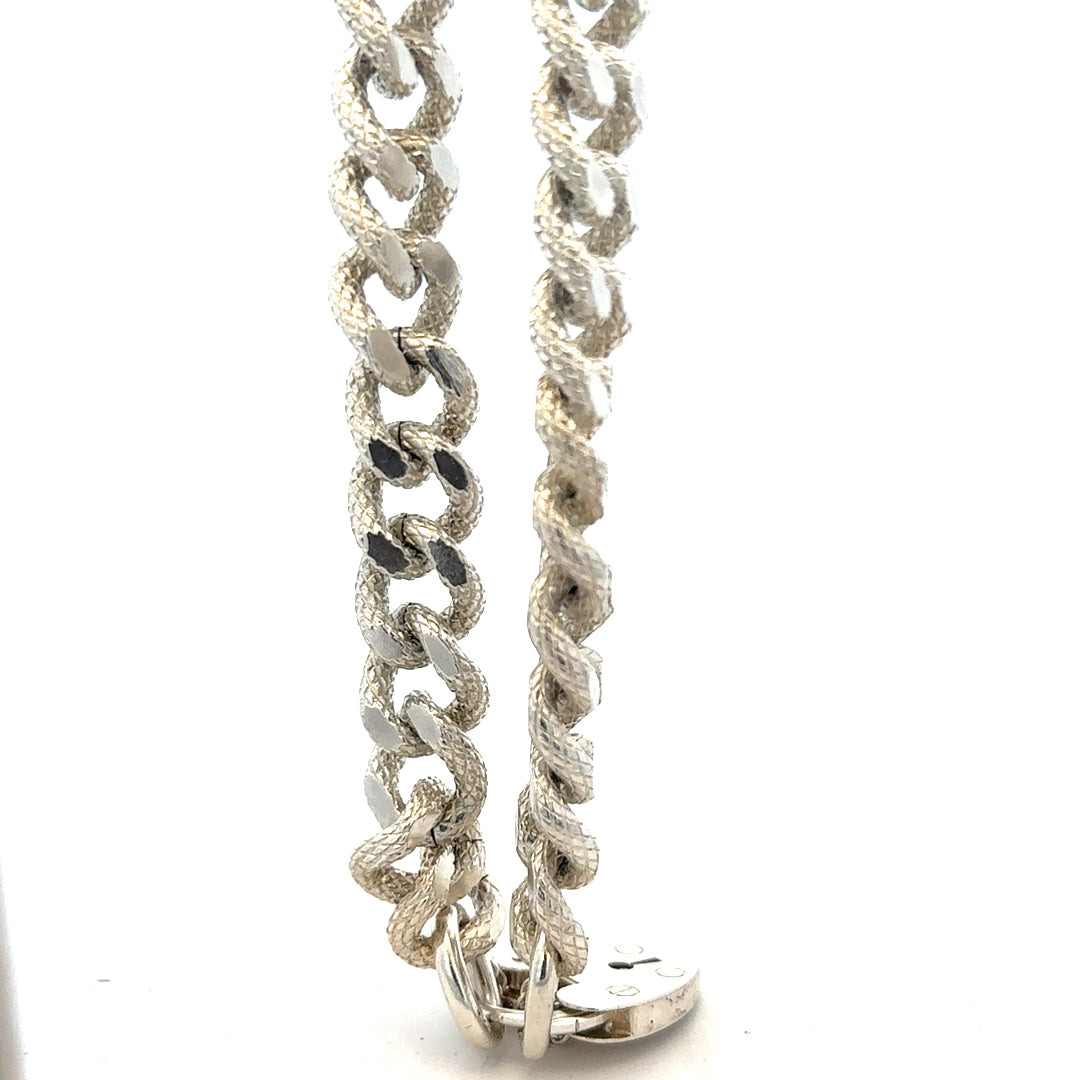 Silver bracelet weighing 64.4g with intricate design, unbranded jewelry accessory, shown in a close-up view