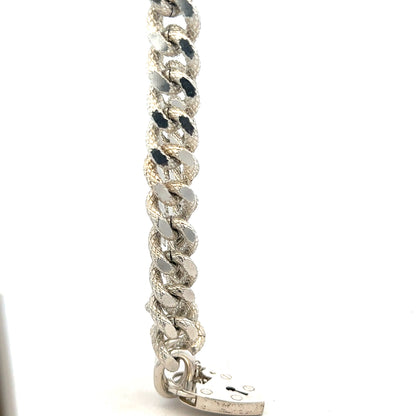 Silver bracelet weighing 64.4g, unbranded jewelry piece with detailed design, shown from a front angle.