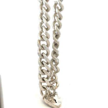 Silver bracelet weighing 64.4g with intricate design, unbranded jewelry accessory, displayed against a neutral background.