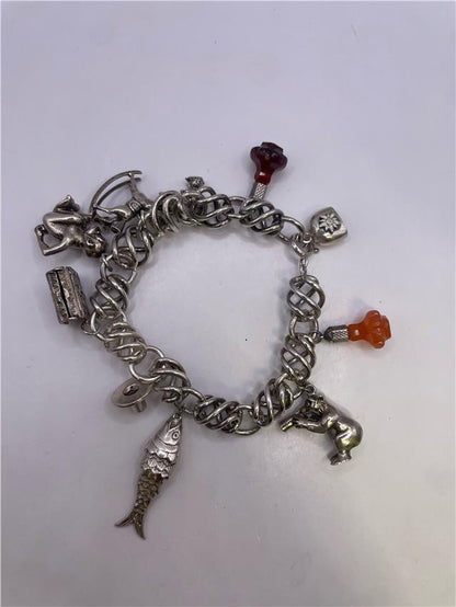 Silver bracelet weighing 73.5 grams, featuring a sleek design, displayed on a neutral background.