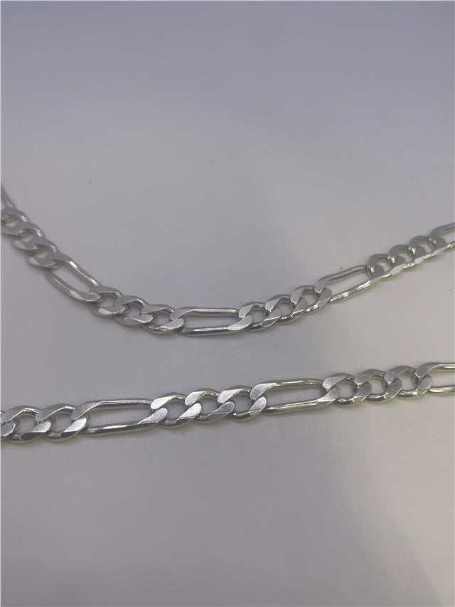 Silver chain weighing 31.5g, unbranded, showcasing its length and intricate link design against a neutral background.