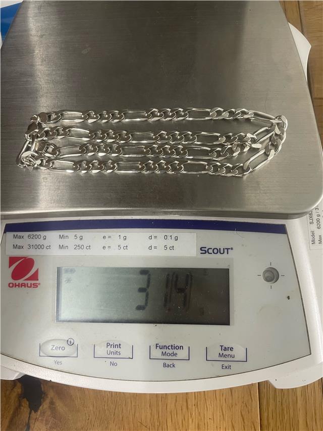 Silver chain weighing 31.5g, unbranded, with a detailed close-up of its smooth, linked design and polished finish.