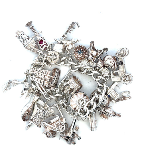 Silver charm bracelet weighing 154.4g, featuring decorative charms and a secure clasp, unbranded jewelry accessory.