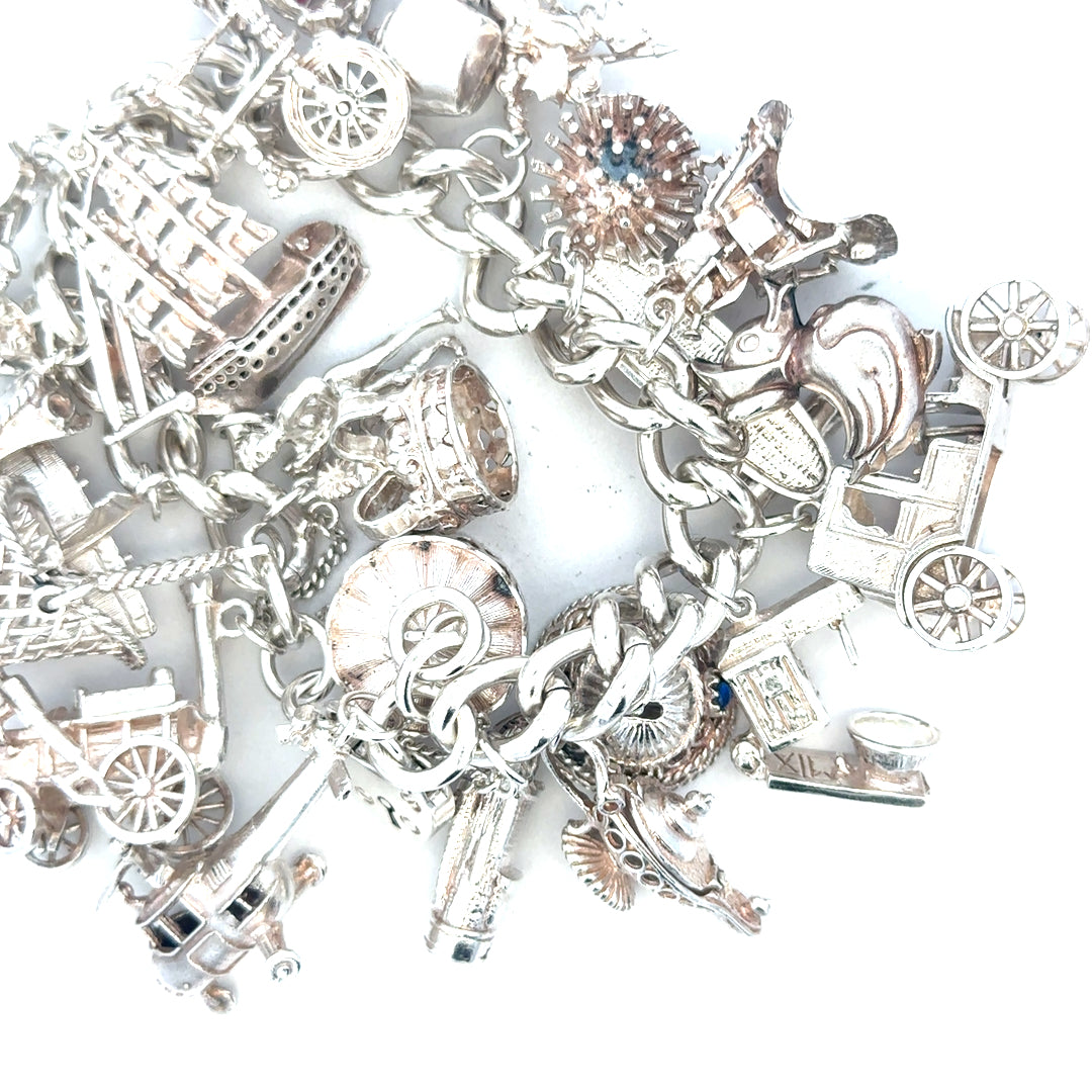 Silver charm bracelet with intricate designs, weighing 154.4g, featuring various decorative charms, unbranded jewelry accessory
