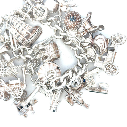 Silver charm bracelet with intricate designs, weighing 154.4g, featuring various decorative charms, unbranded jewelry accessory