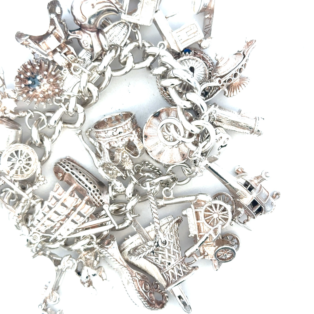 Silver charm bracelet weighing 154.4g with detailed charms, unbranded jewelry accessory for stylish wear.