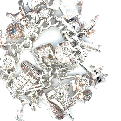 Silver charm bracelet weighing 154.4g with detailed charms, unbranded jewelry accessory for stylish wear.