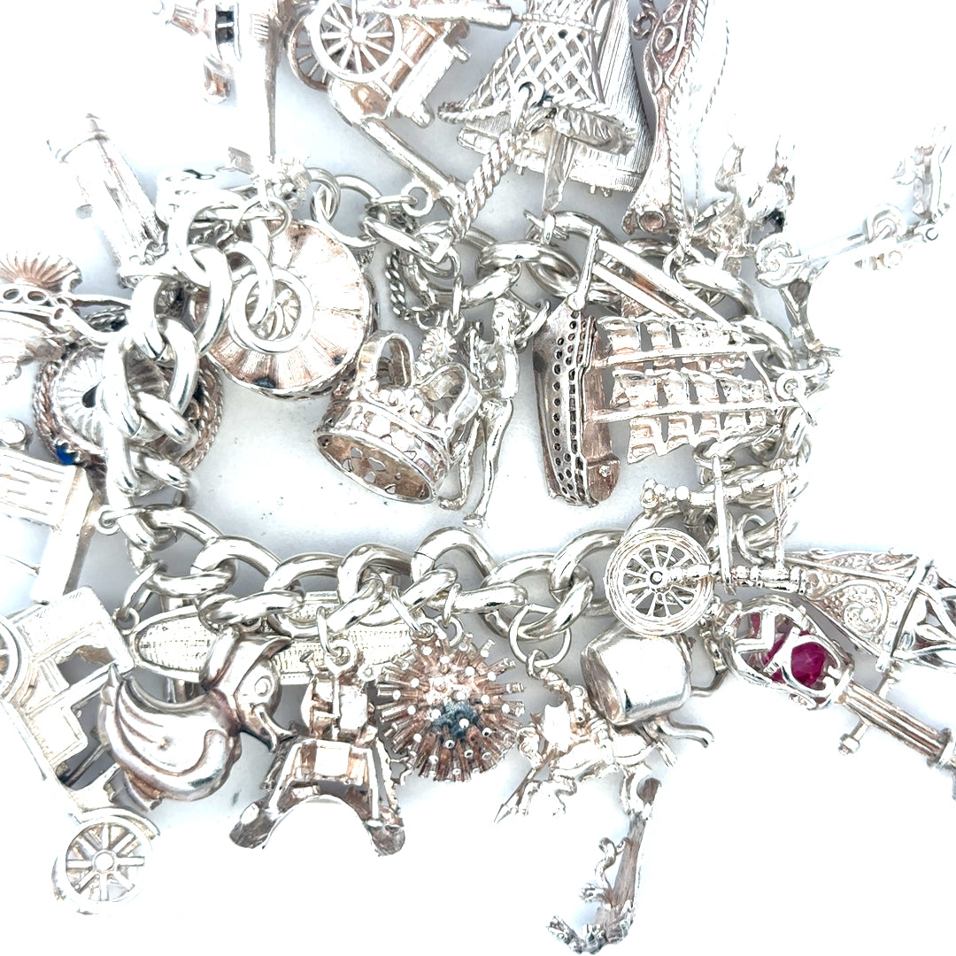 Silver charm bracelet weighing 154.4g with decorative charms, unbranded jewelry accessory, displayed on a plain background.