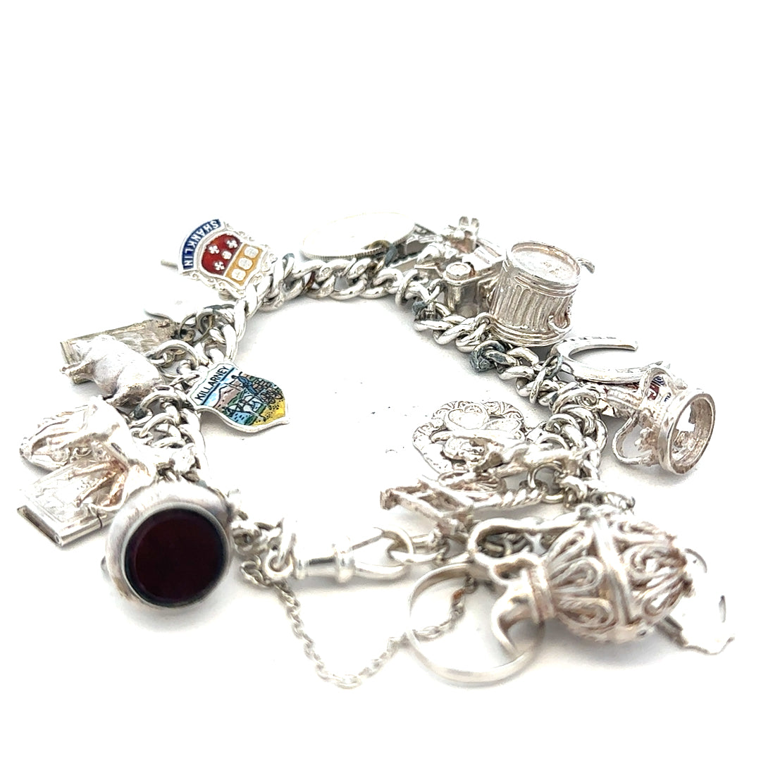 Silver charm bracelet weighing 61g with intricate charms, crafted in a stylish unbranded design.