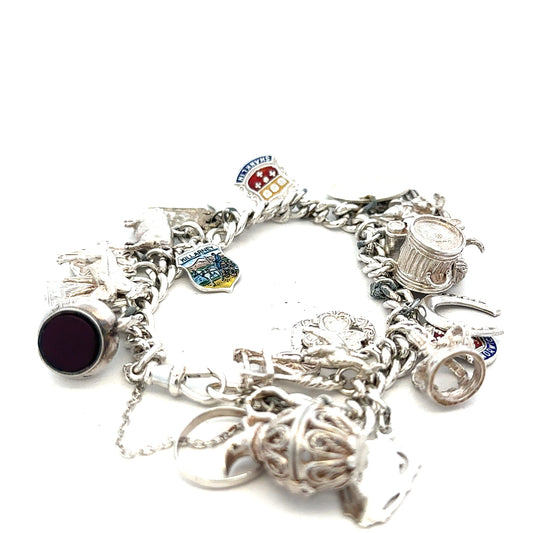 Silver charm bracelet weighing 61g with various decorative charms, unbranded jewelry accessory on a neutral background.