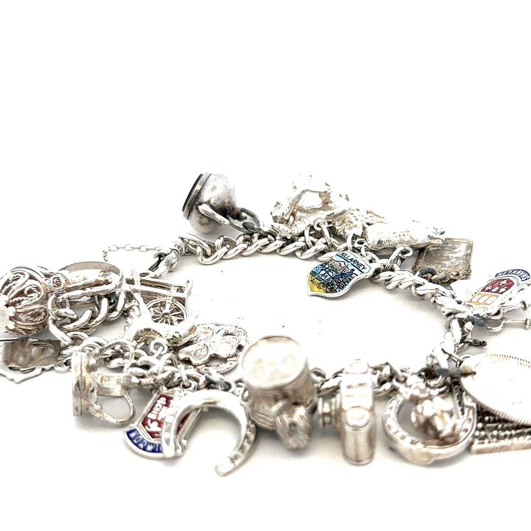 Silver charm bracelet weighing 61g with multiple charms, featuring a sleek unbranded design and silver finish.