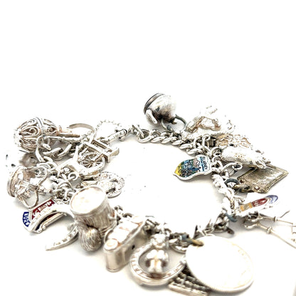 Silver charm bracelet featuring intricate designs, weighing 61g, with detailed charms on a sleek bracelet style.