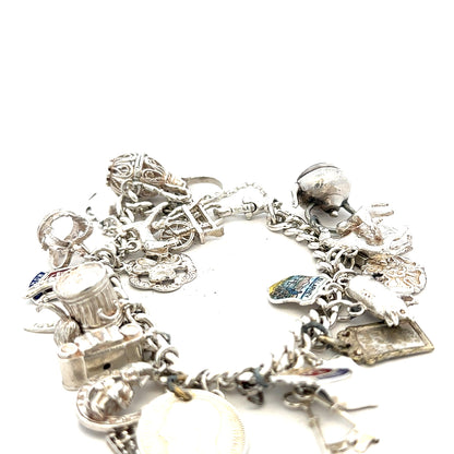 Silver charm bracelet weighing 61g with decorative charms, unbranded jewelry accessory on a neutral background.