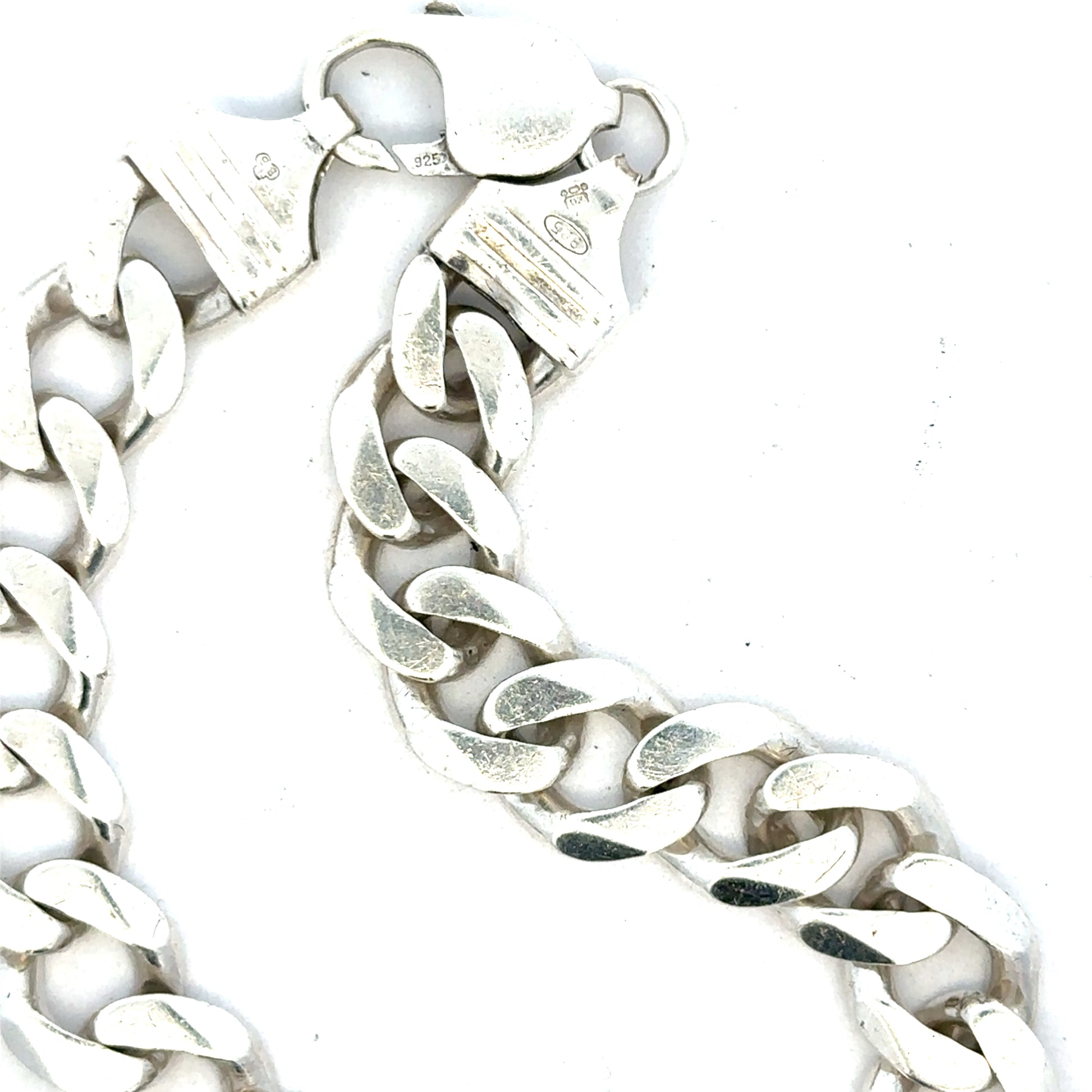 Silver curb bracelet weighing 33.7g, featuring interlinked flat, wide links in a classic design, unbranded jewelry accessory.