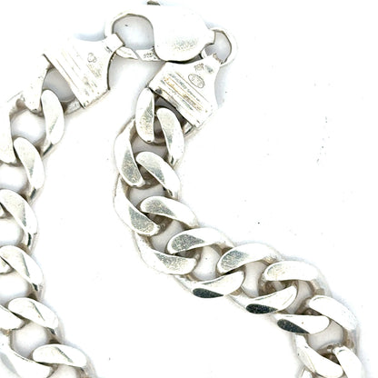 Silver curb bracelet weighing 33.7g, featuring interlinked flat, wide links in a classic design, unbranded jewelry accessory.