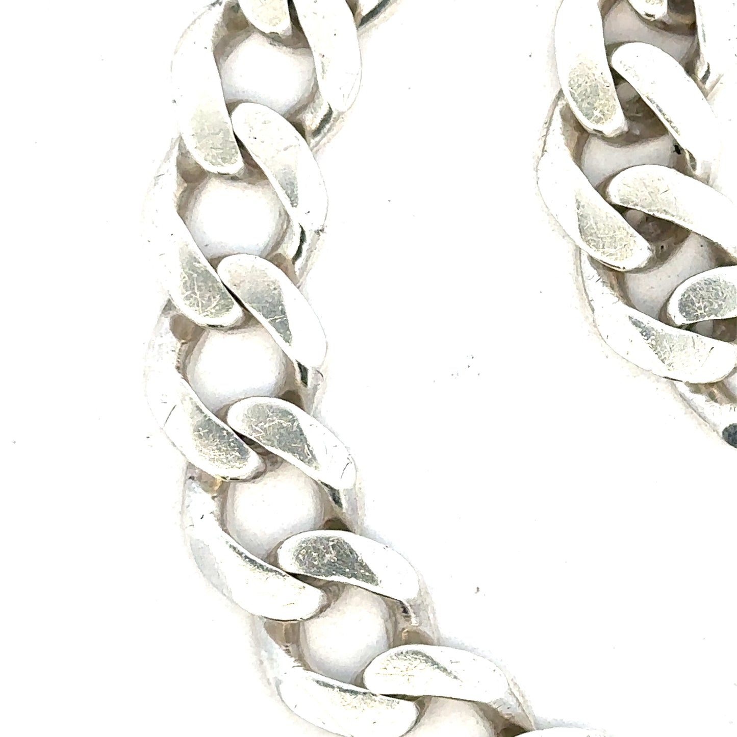 Silver curb bracelet weighing 33.7g, unbranded jewelry accessory with sleek links, showcased in a detailed product image.