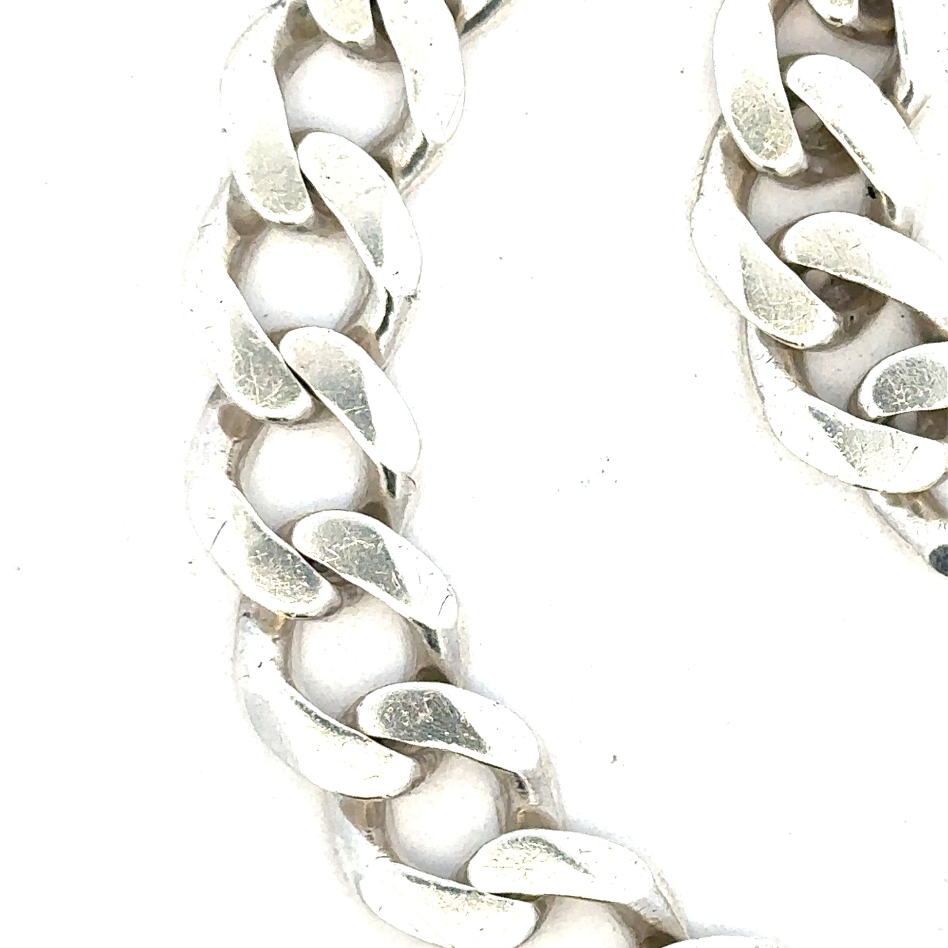 Silver curb bracelet weighing 33.7g, unbranded jewelry accessory with sleek links, showcased in a detailed product image.