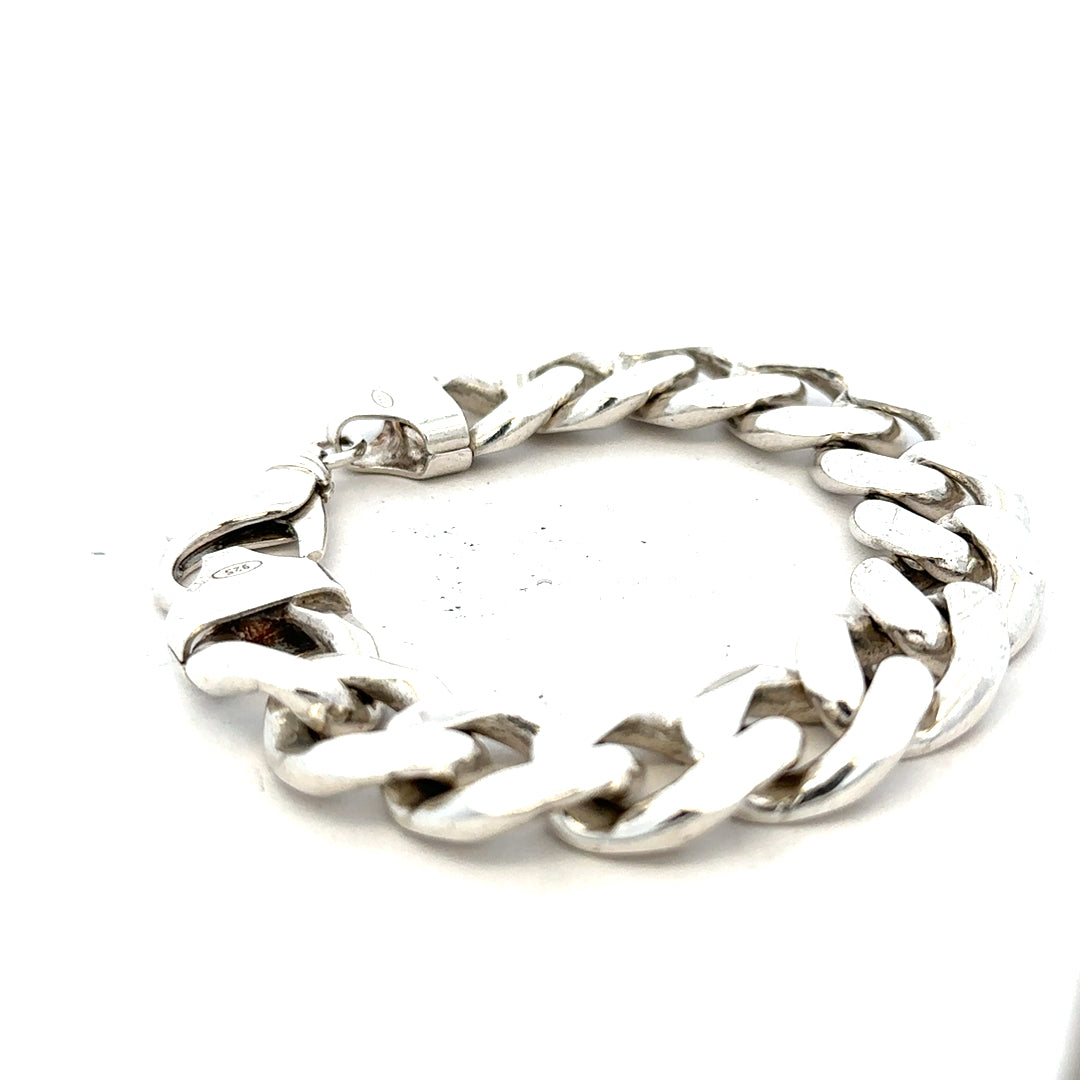 Silver curb bracelet weighing 90.1g, unbranded jewelry accessory with linked curb chain design.