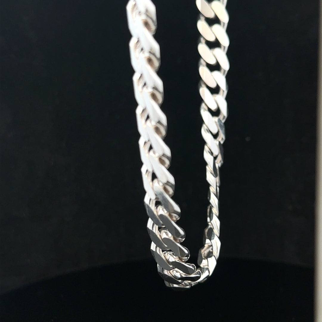 Silver curb chain weighing 109.9g, unbranded jewelry chain with a sleek, classic design, shown laid flat in the image.