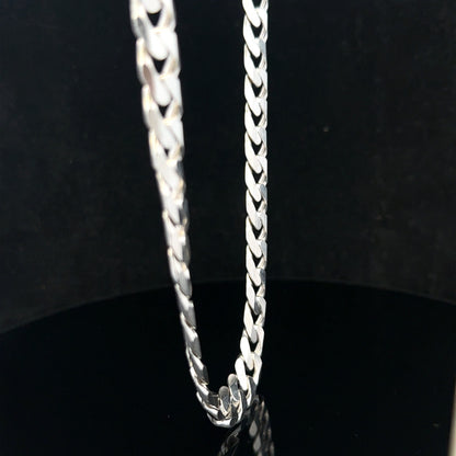 Silver curb chain weighing 60.4g, featuring classic linked design, crafted for jewelry or fashion accessories.