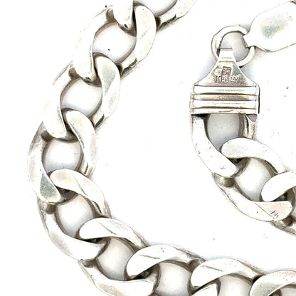 Silver curb chain weighing 80.2g, displayed in a natural pose, showcasing its detailed linked design and shiny finish.