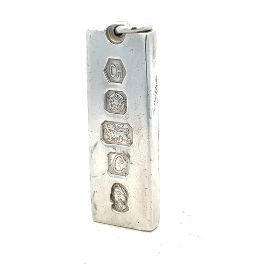 Silver ingot pendant weighing 31g, unbranded jewelry piece with a sleek metallic finish and simple design.